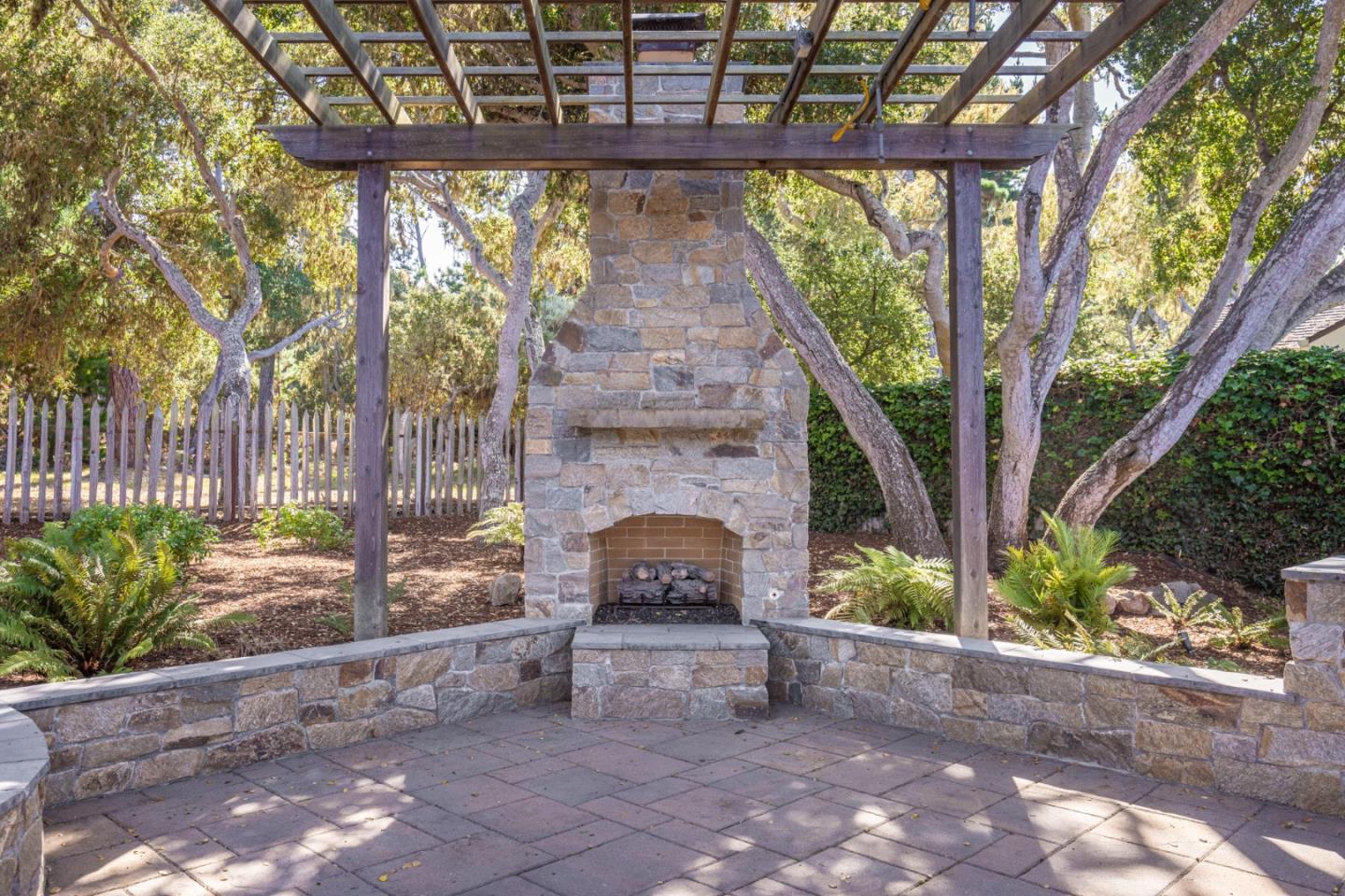 3125 Bird Rock Road Pebble Beach, CA 93953 - Photo 26 of 35 a view of a patio with a fireplace in front of it
