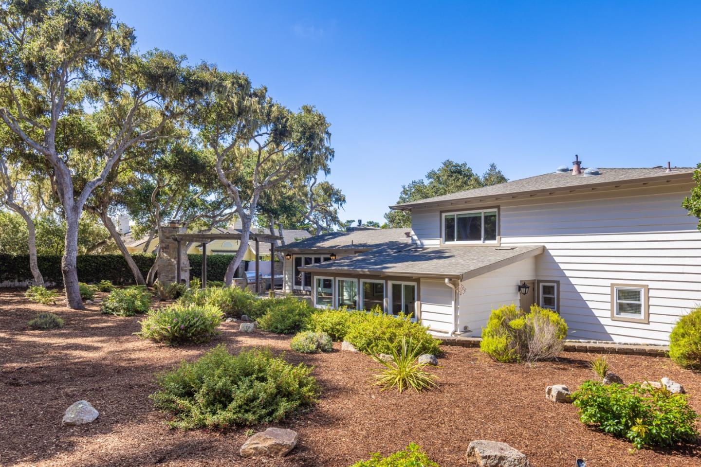 3125 Bird Rock Road Pebble Beach, CA 93953 - Photo 30 of 35 a yellow house with trees in front of it