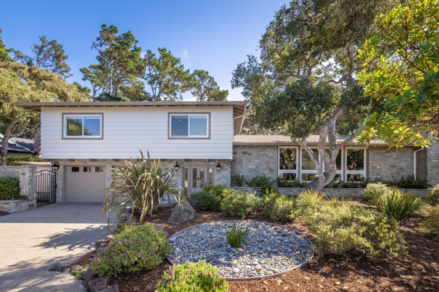 3125 Bird Rock Road Pebble Beach, CA 93953 - Photo 3 of 35 a front view of a house with garden