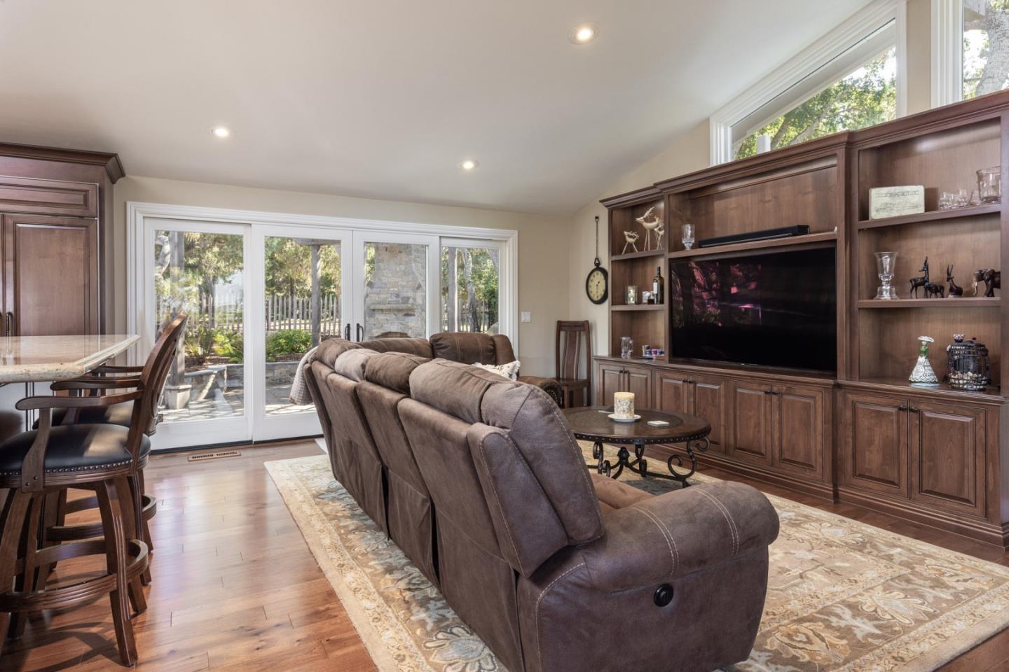 3125 Bird Rock Road Pebble Beach, CA 93953 - Photo 8 of 35 a living room with furniture a flat screen tv and a floor to ceiling window