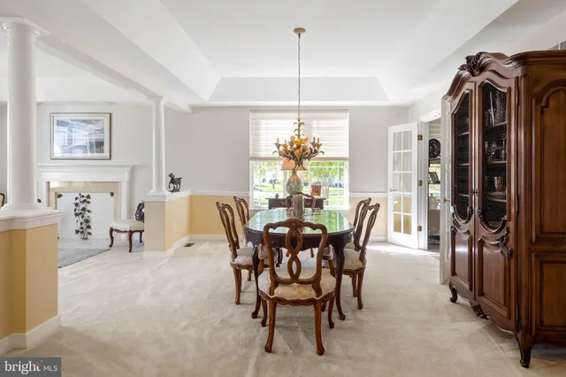 a living room with furniture a fireplace and a large window