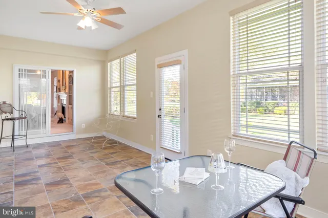 a living room with furniture a clock and a large window
