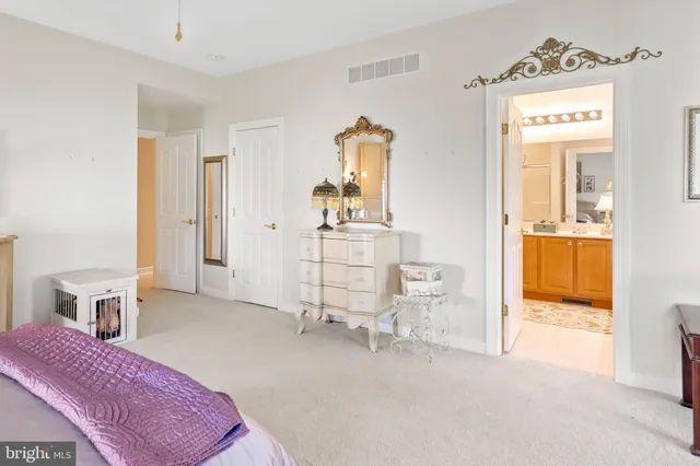 a bedroom with furniture and a large window