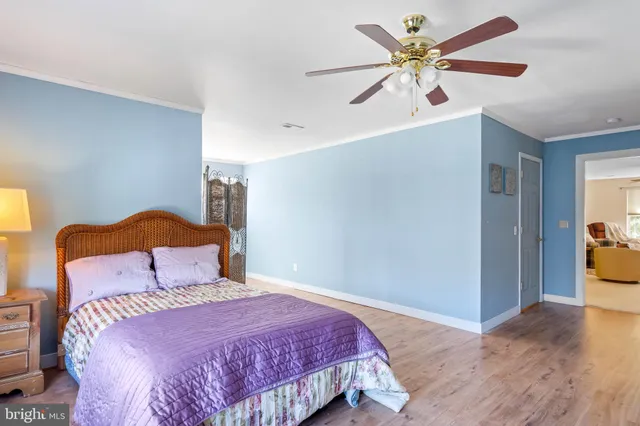 a view of a brick house with a yard and plants