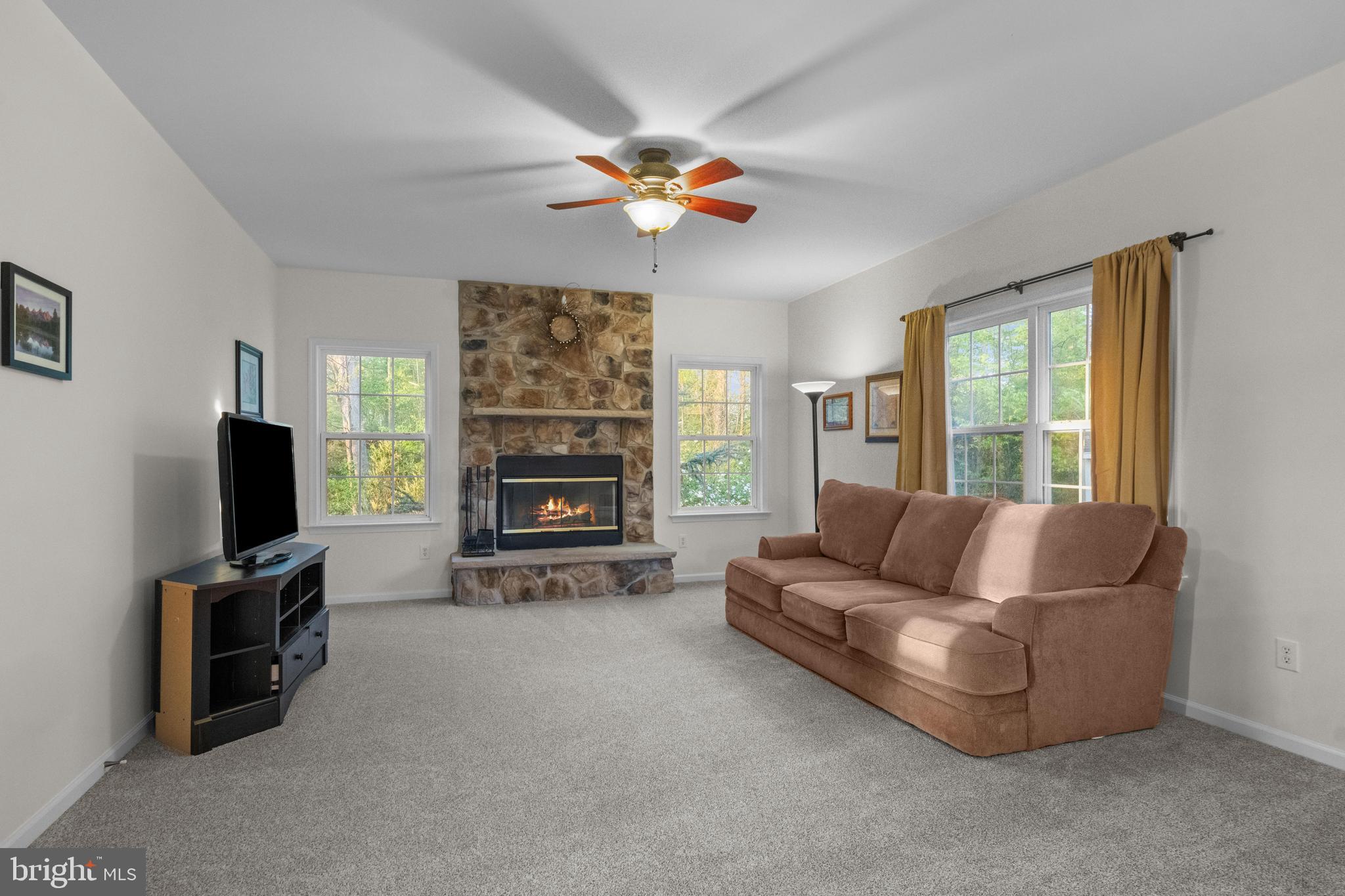 419 Townsend Drive Perkasie, PA 18944 - Photo 12 of 37 a living room with furniture a fireplace and a flat screen tv