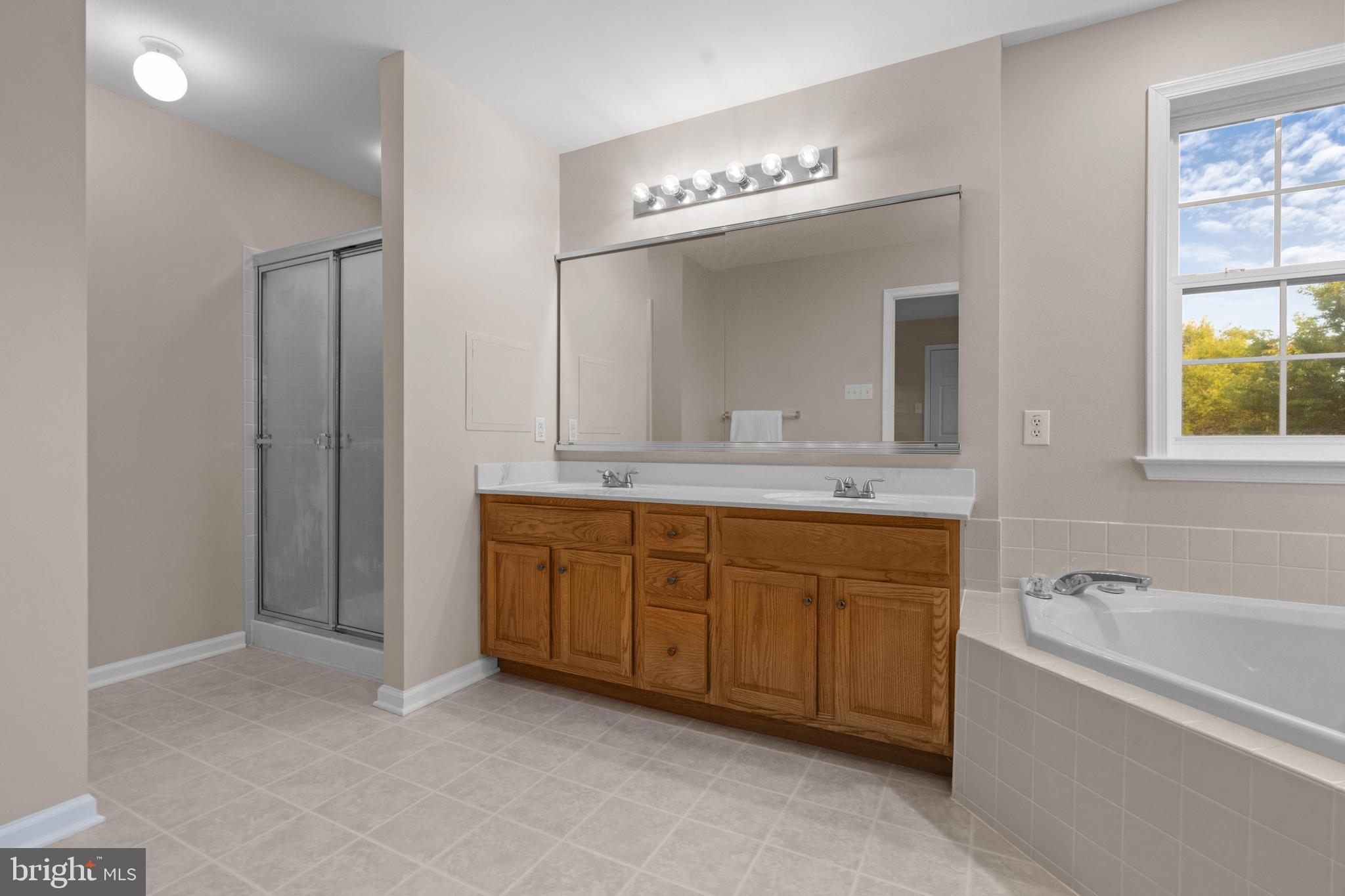 419 Townsend Drive Perkasie, PA 18944 - Photo 22 of 37 a spacious bathroom with a granite countertop double vanity sink a mirror and a bathtub