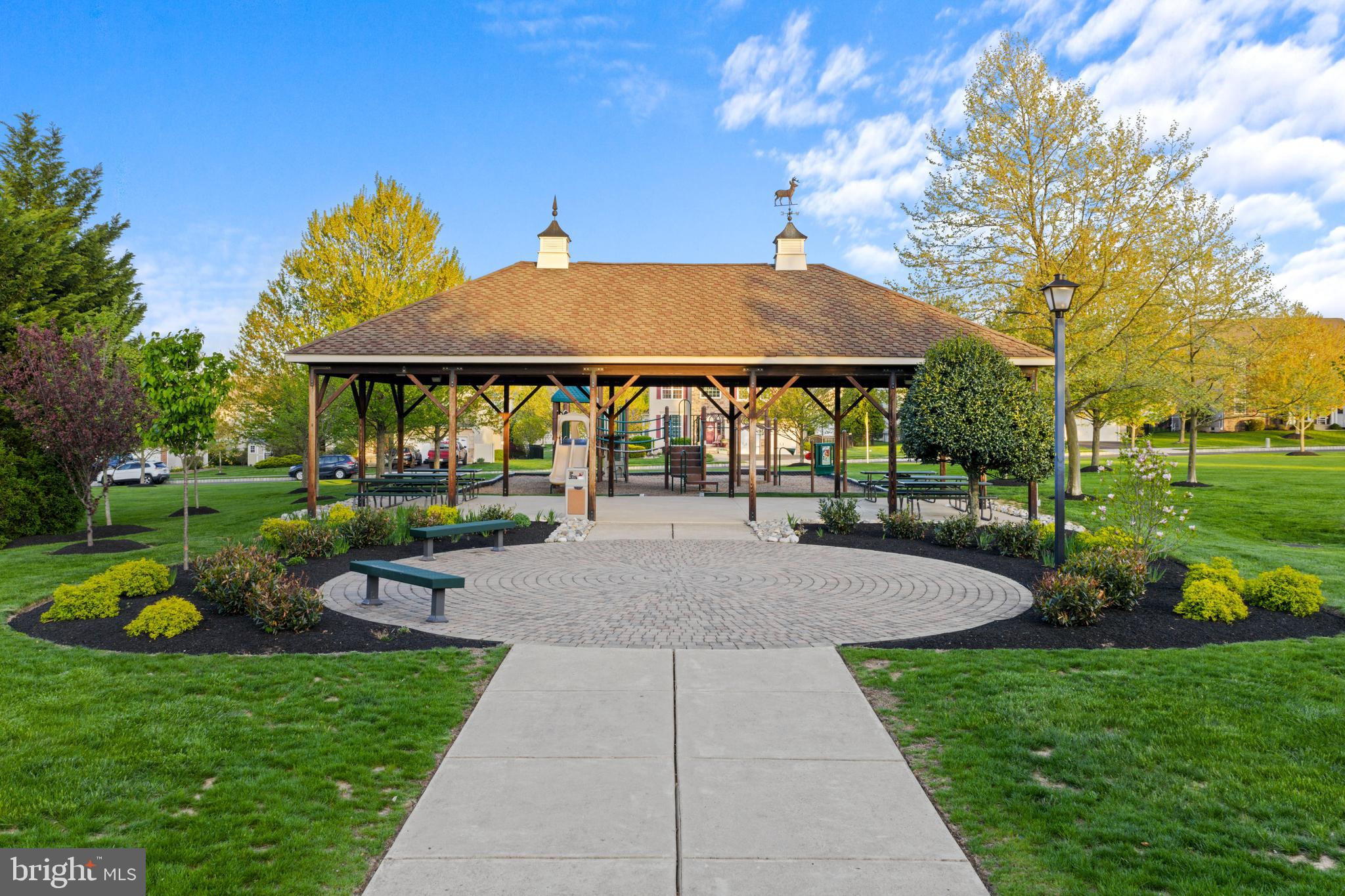 419 Townsend Drive Perkasie, PA 18944 - Photo 35 of 37 a patio with a table and chairs under an umbrella