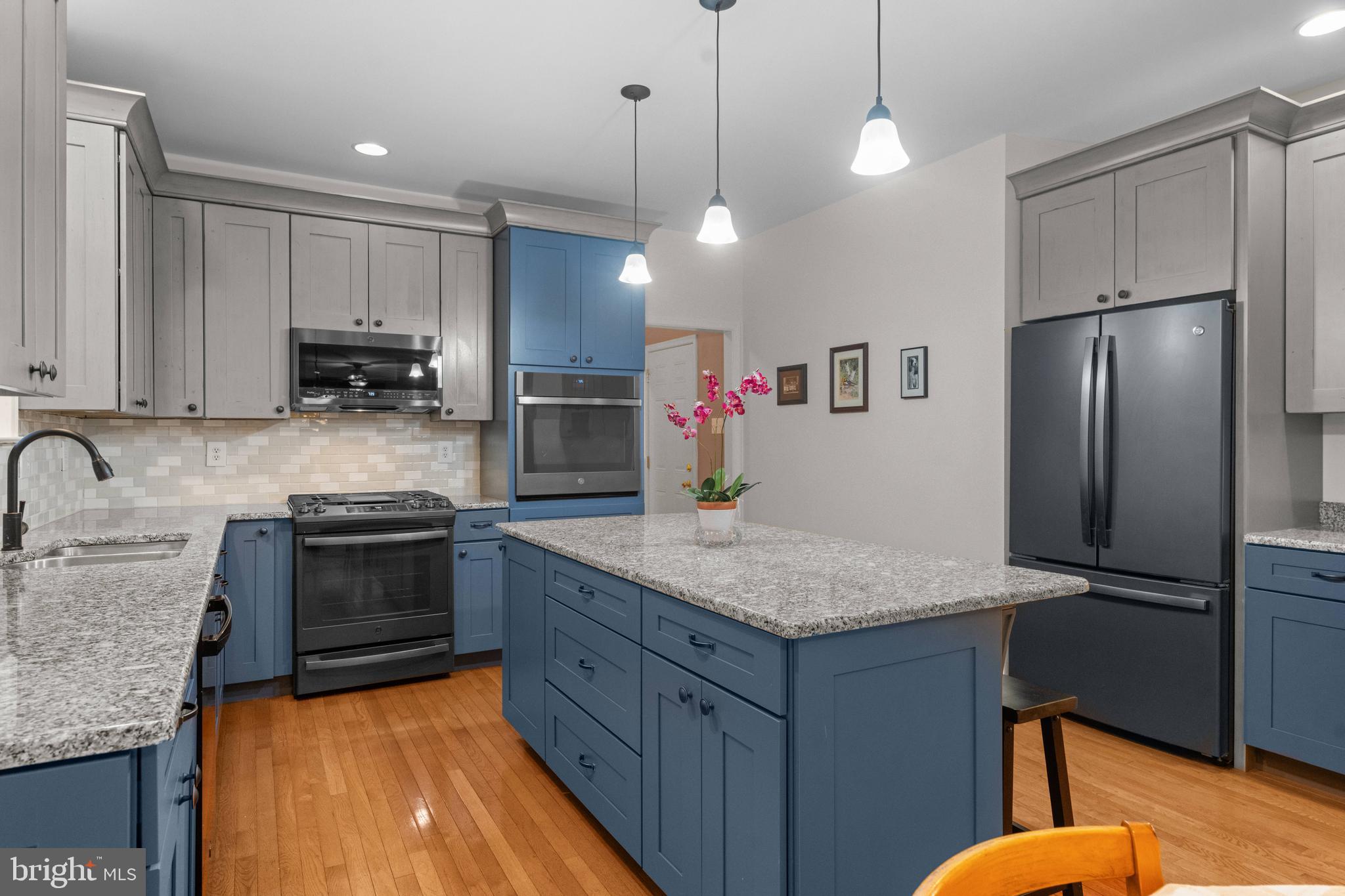 419 Townsend Drive Perkasie, PA 18944 - Photo 5 of 37 a kitchen with stainless steel appliances granite countertop a sink refrigerator and cabinets