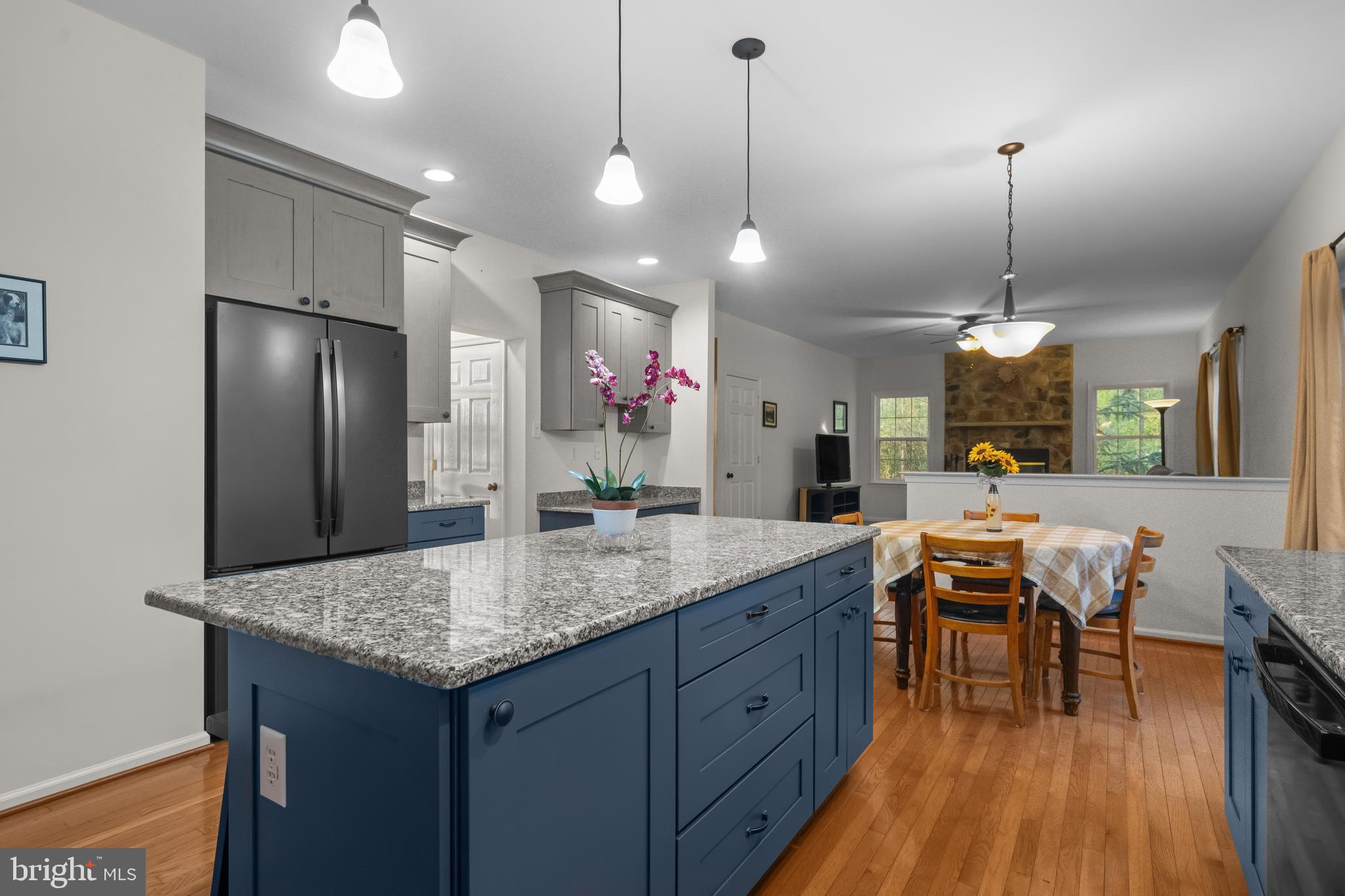 419 Townsend Drive Perkasie, PA 18944 - Photo 6 of 37 a kitchen with granite countertop sink refrigerator and wooden floor