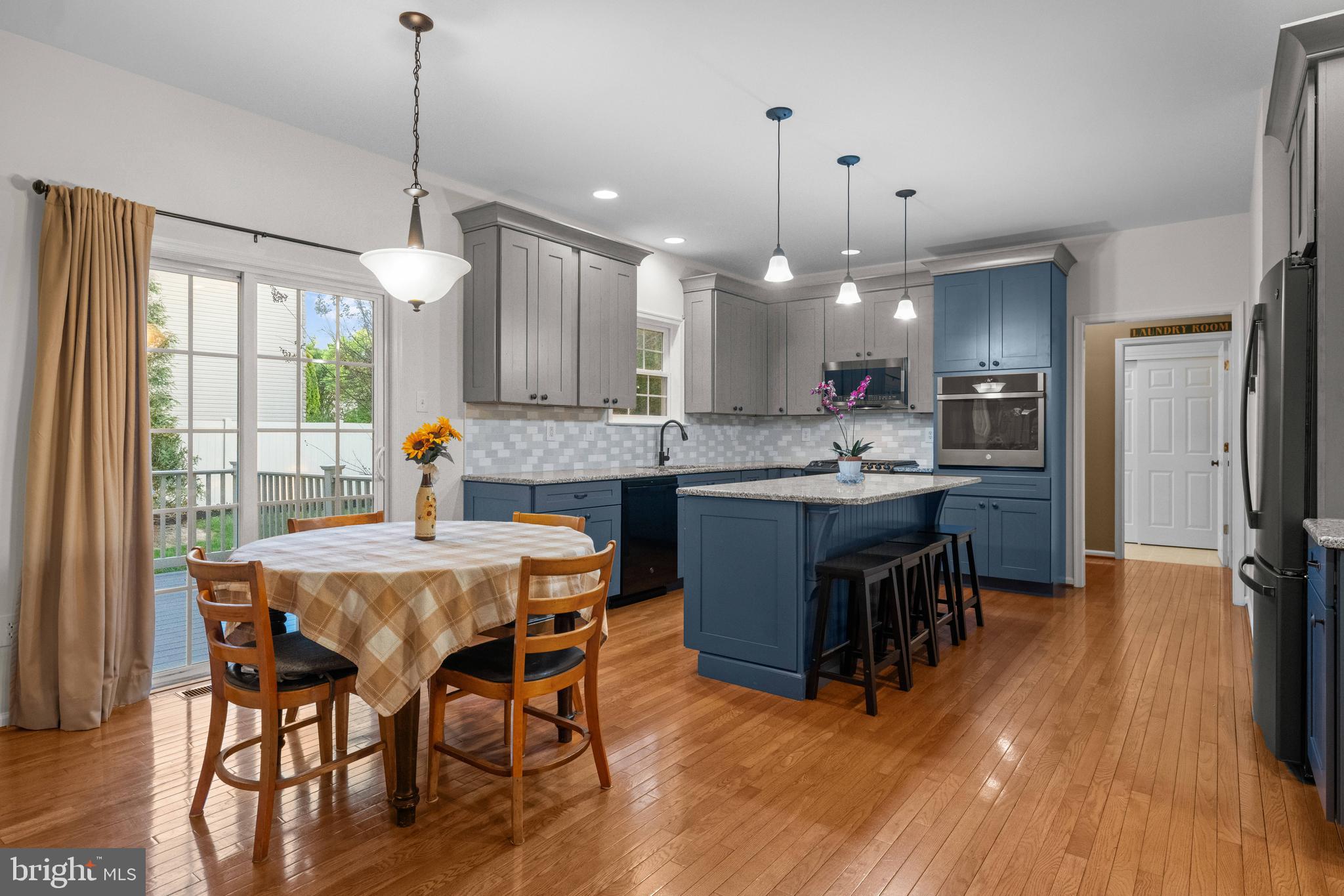 419 Townsend Drive Perkasie, PA 18944 - Photo 9 of 37 a kitchen with stainless steel appliances granite countertop a stove a refrigerator a kitchen island a sink and a wooden floor