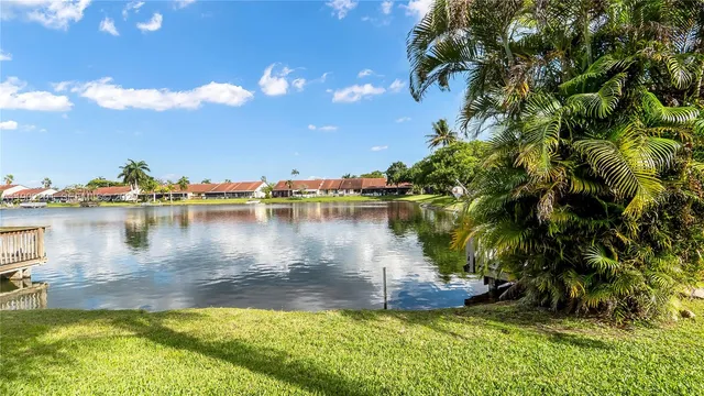 a view of a lake with houses in the back
