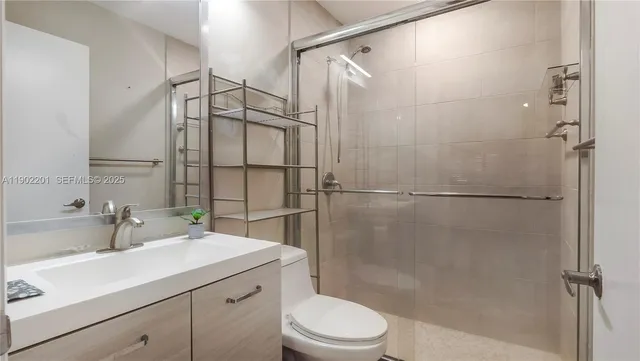 a bathroom with a sink toilet and shower