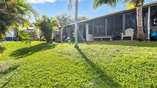 a backyard of a house with yard and outdoor seating