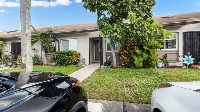 a view of backyard with seating area and green space
