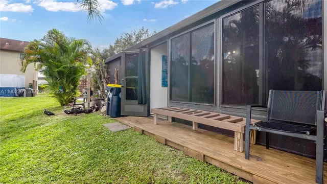 a view of a house with backyard and sitting area