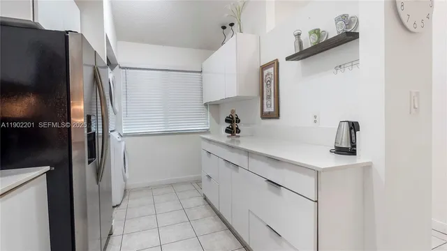 a kitchen with a sink and refrigerator