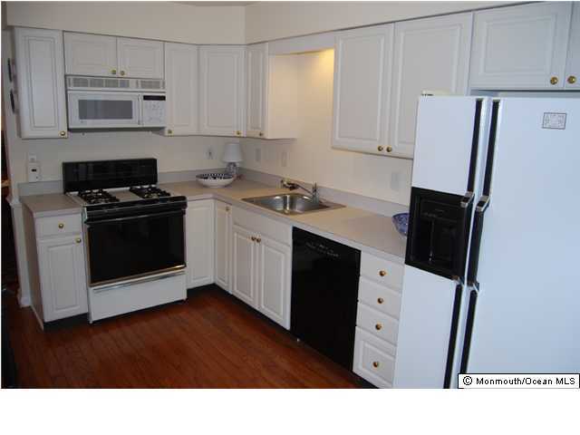 2 Painted Wagon Road Holmdel, NJ 07733 - Photo 3 of 3 a kitchen with stainless steel appliances a stove a refrigerator a sink and white cabinets