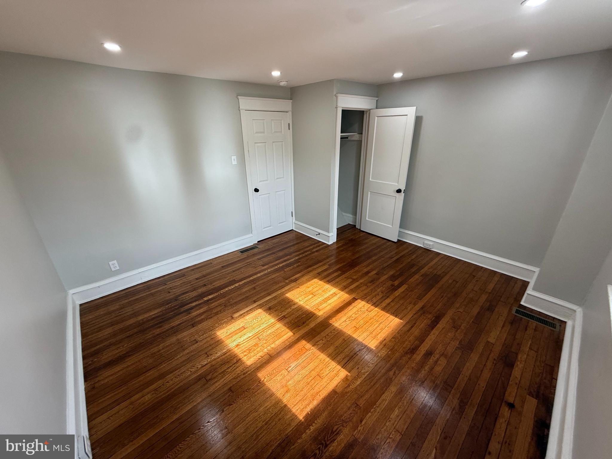 413 Copley Road Upper Darby, PA 19082 - Photo 11 of 21 an empty room with wooden floor and windows