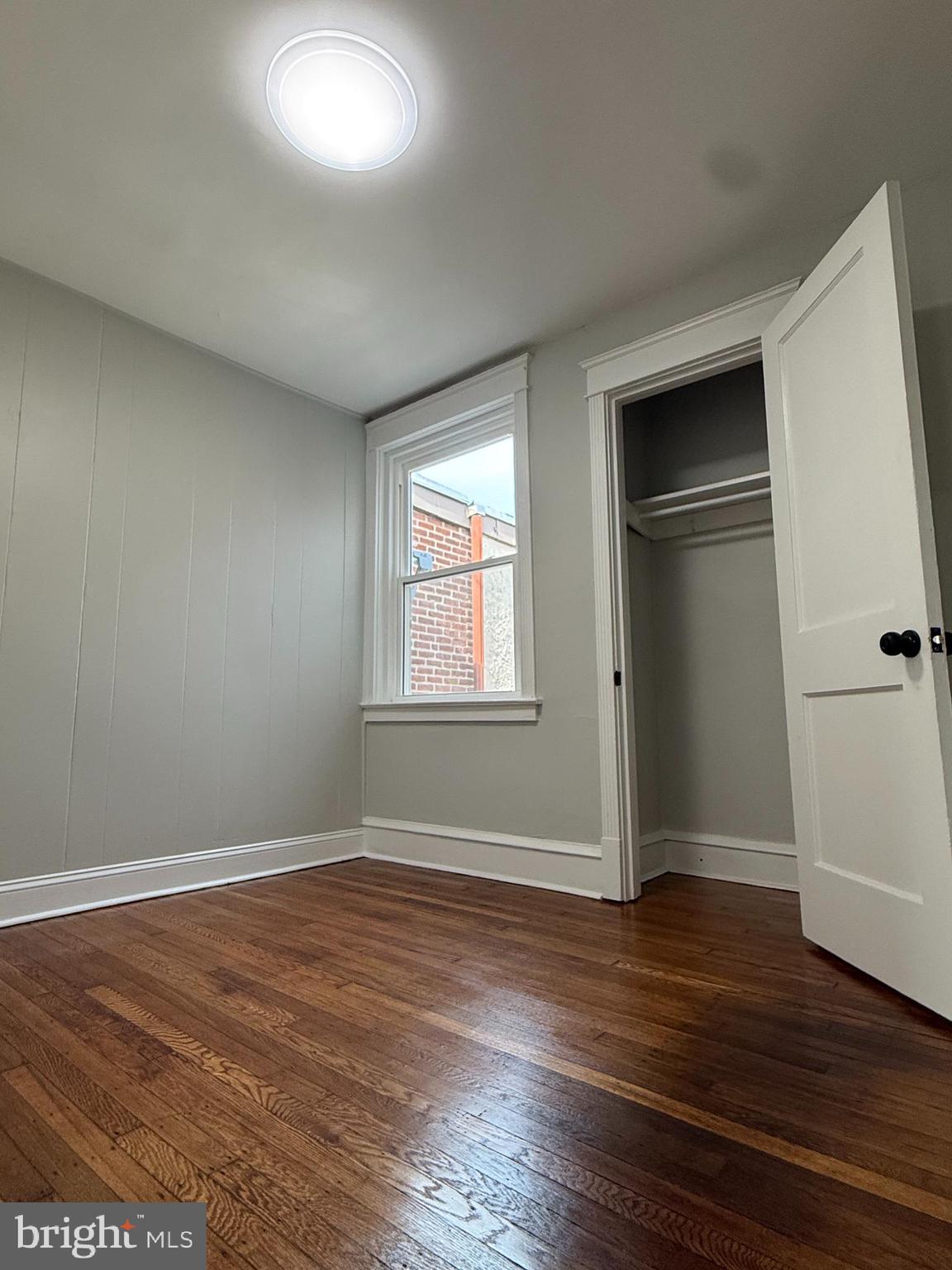 413 Copley Road Upper Darby, PA 19082 - Photo 13 of 21 an empty room with wooden floor cabinet and windows