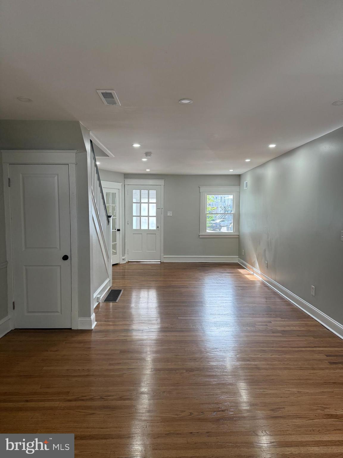 413 Copley Road Upper Darby, PA 19082 - Photo 3 of 21 a view of empty room with wooden floor and fan