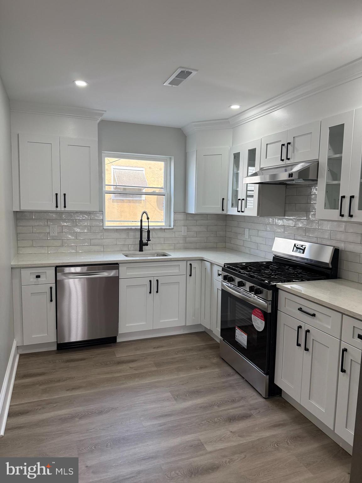 413 Copley Road Upper Darby, PA 19082 - Photo 5 of 21 a large kitchen with stainless steel appliances granite countertop a stove a sink dishwasher and a refrigerator