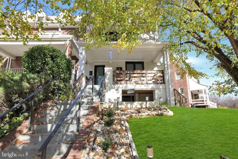 a room with stainless steel appliances kitchen island granite countertop furniture and a fireplace
