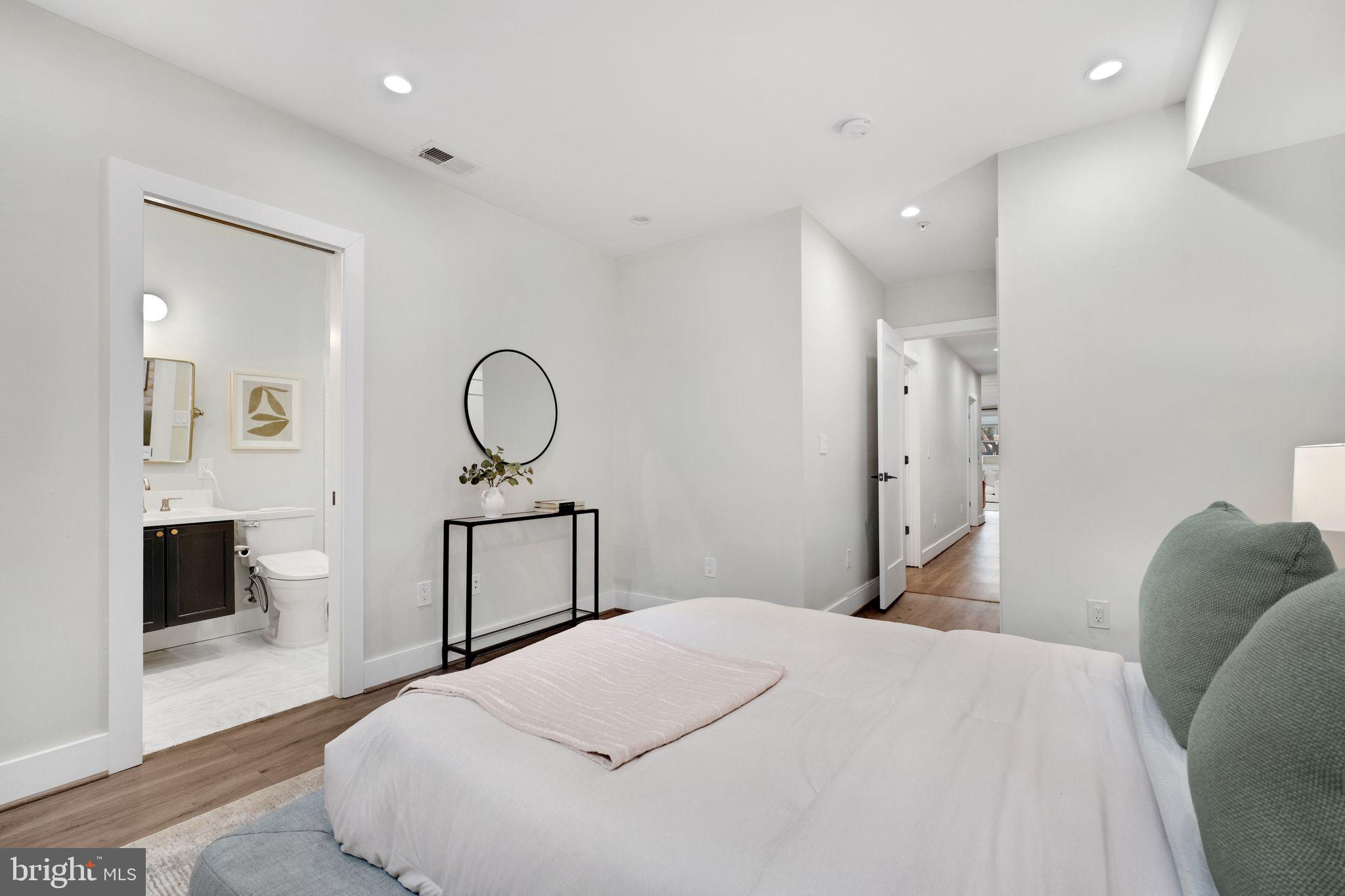 1419 Upshur Street Northwest, Unit 1 Washington, DC 20011 - Photo 12 of 28 a bedroom with a bed and a flat screen tv