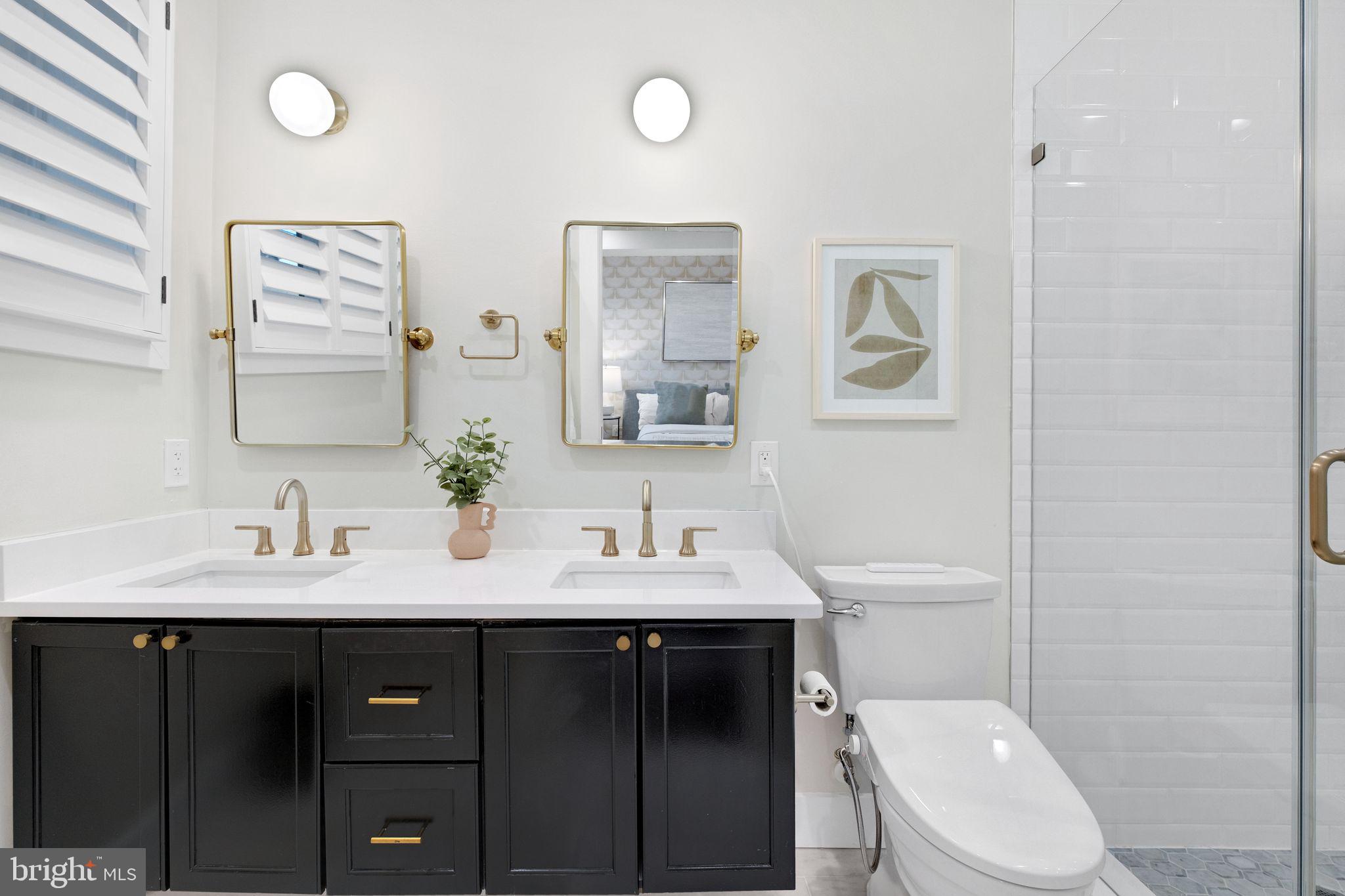 1419 Upshur Street Northwest, Unit 1 Washington, DC 20011 - Photo 15 of 28 a bathroom with a toilet a sink and mirror