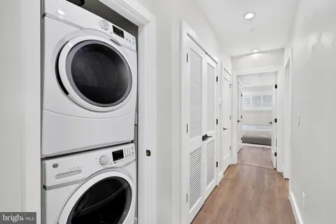 a view of a hallway with washer and dryer