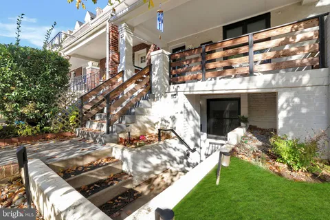 a view of a patio with couches table and chairs and potted plants