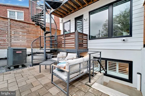 a outdoor space with patio the couches and a fireplace