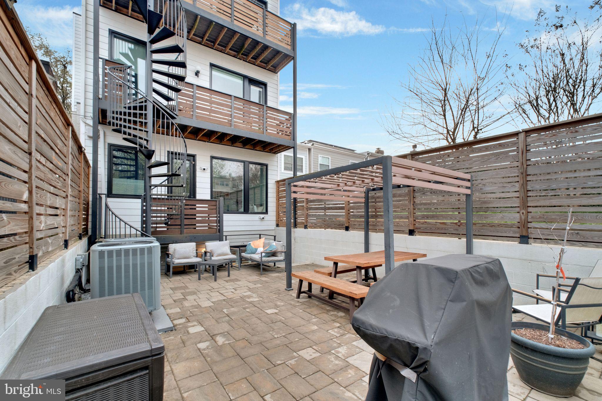 1419 Upshur Street Northwest, Unit 1 Washington, DC 20011 - Photo 27 of 28 a outdoor space with patio the couches and a fireplace