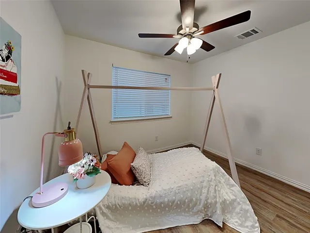 a bedroom with a bed and ceiling fan