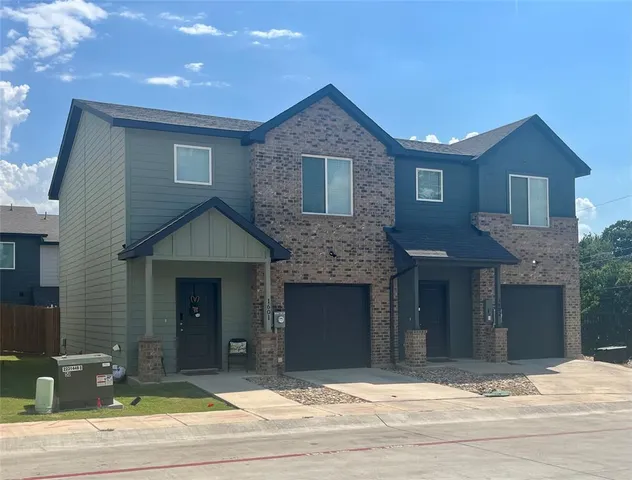 a front view of a house with garage