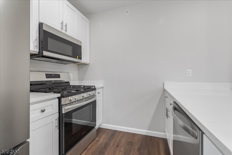 224 Broad Street Bloomfield, NJ 07003 - Photo 11 of 45 a kitchen with a stove and a microwave
