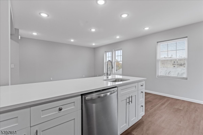 224 Broad Street Bloomfield, NJ 07003 - Photo 13 of 45 a kitchen with a sink and dishwasher with wooden floor