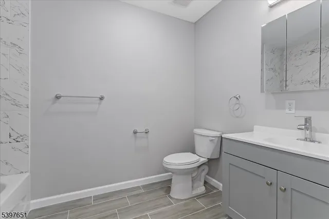 a bathroom with a sink toilet and vanity