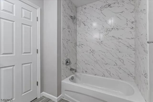 a bathroom with bathtub and shower