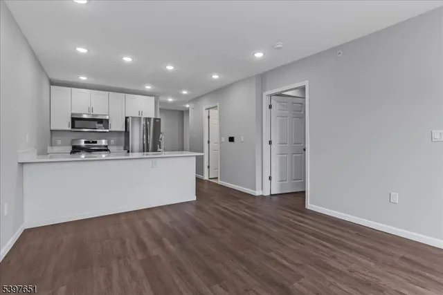 a kitchen with stainless steel appliances a refrigerator and a stove top oven