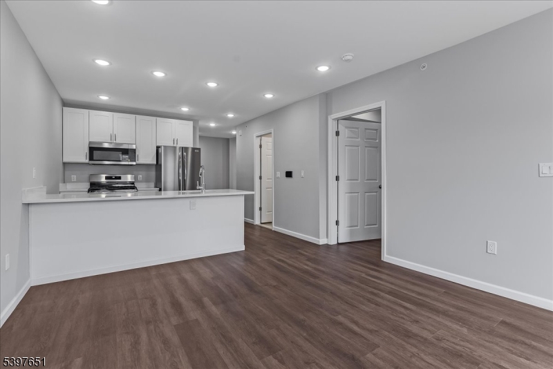 224 Broad Street Bloomfield, NJ 07003 - Photo 16 of 45 a kitchen with stainless steel appliances a refrigerator and a stove top oven