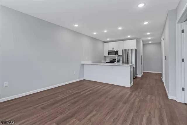 a view of a kitchen with a sink and a refrigerator
