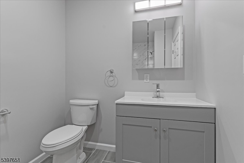 224 Broad Street Bloomfield, NJ 07003 - Photo 18 of 45 a bathroom with a toilet a sink and mirror