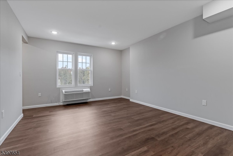 224 Broad Street Bloomfield, NJ 07003 - Photo 19 of 45 a view of an empty room with wooden floor and a window