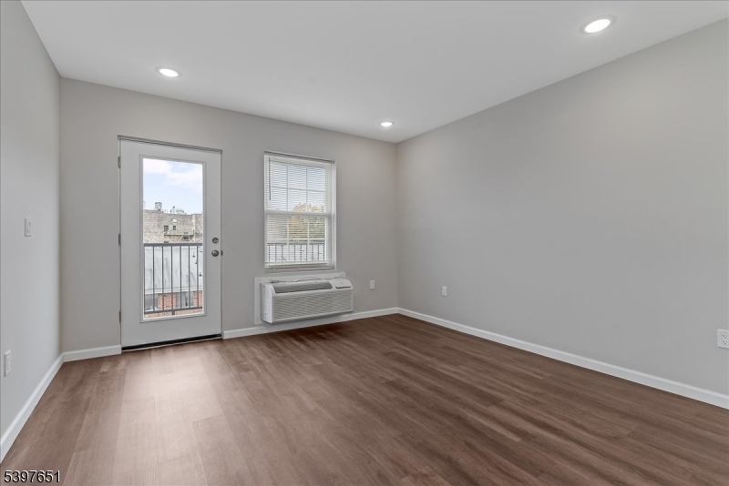 224 Broad Street Bloomfield, NJ 07003 - Photo 27 of 45 a view of empty room with wooden floor and fan