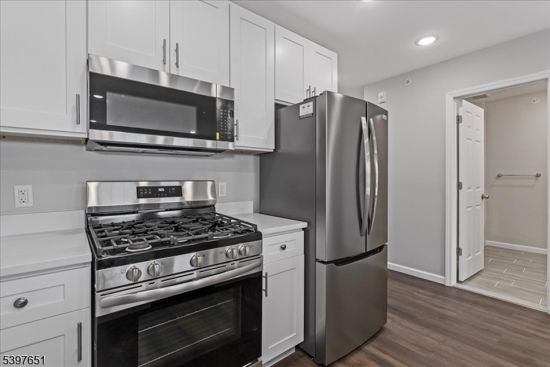 224 Broad Street Bloomfield, NJ 07003 - Photo 32 of 45 a kitchen with stainless steel appliances a refrigerator a stove top oven a sink and cabinets