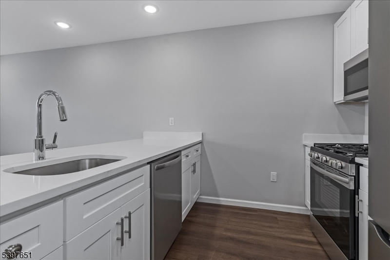 224 Broad Street Bloomfield, NJ 07003 - Photo 34 of 45 a kitchen with a sink and stainless steel appliances
