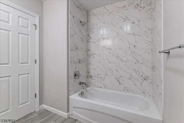 a bathroom with bathtub and shower