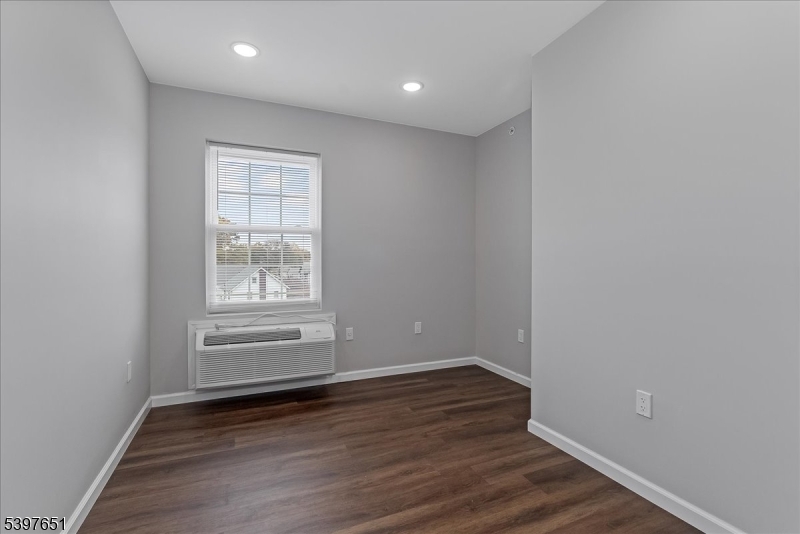 224 Broad Street Bloomfield, NJ 07003 - Photo 40 of 45 wooden floor in an empty room with a window