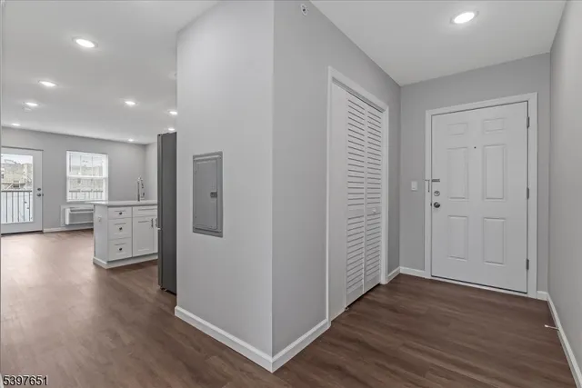 a view of a hallway with wooden floor