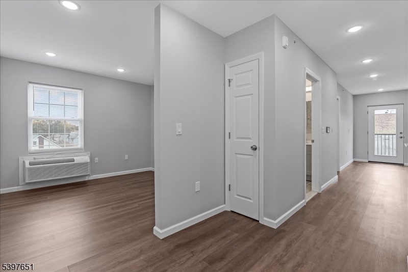 224 Broad Street Bloomfield, NJ 07003 - Photo 42 of 45 an empty room with wooden floor and windows